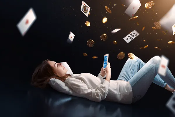 A young woman relaxing with her phone while dynamic casino elements float around her, illustrating the smooth mobile experience offered by the CBAJI app.
